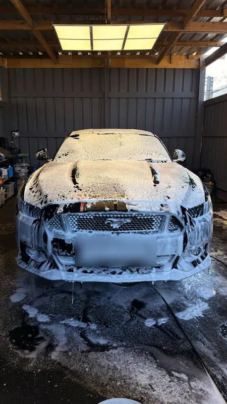 Ford Mustang covered in snow foam inside the OMVA studio